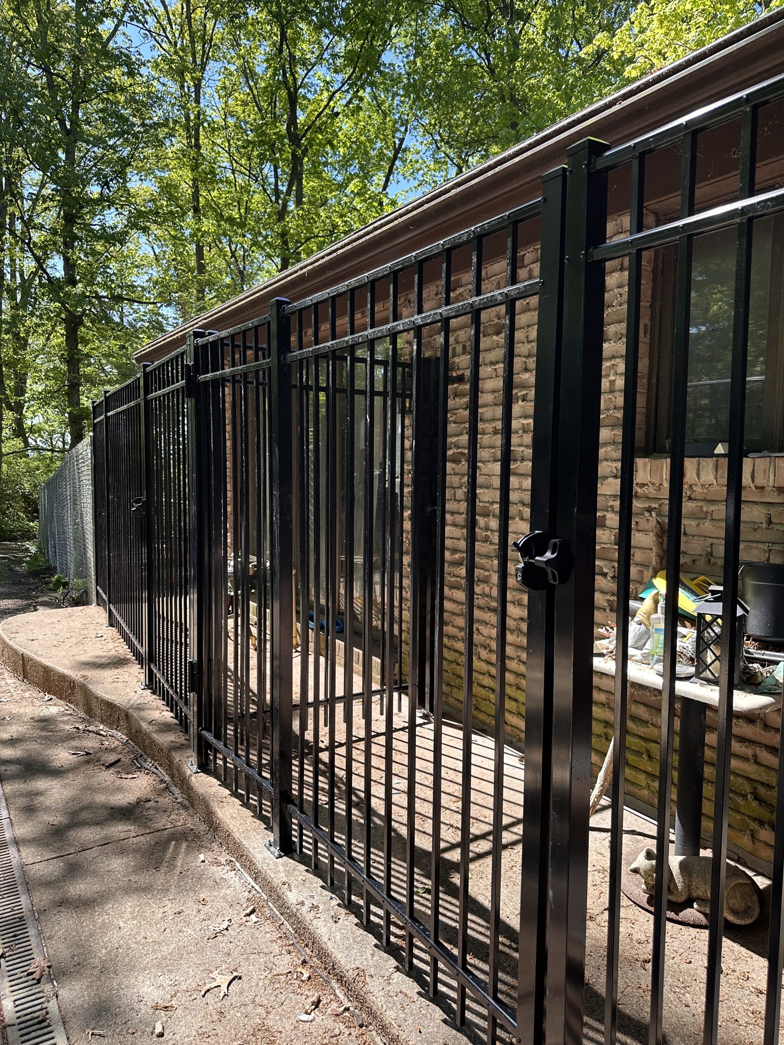 Black chain link fence around a patio yard