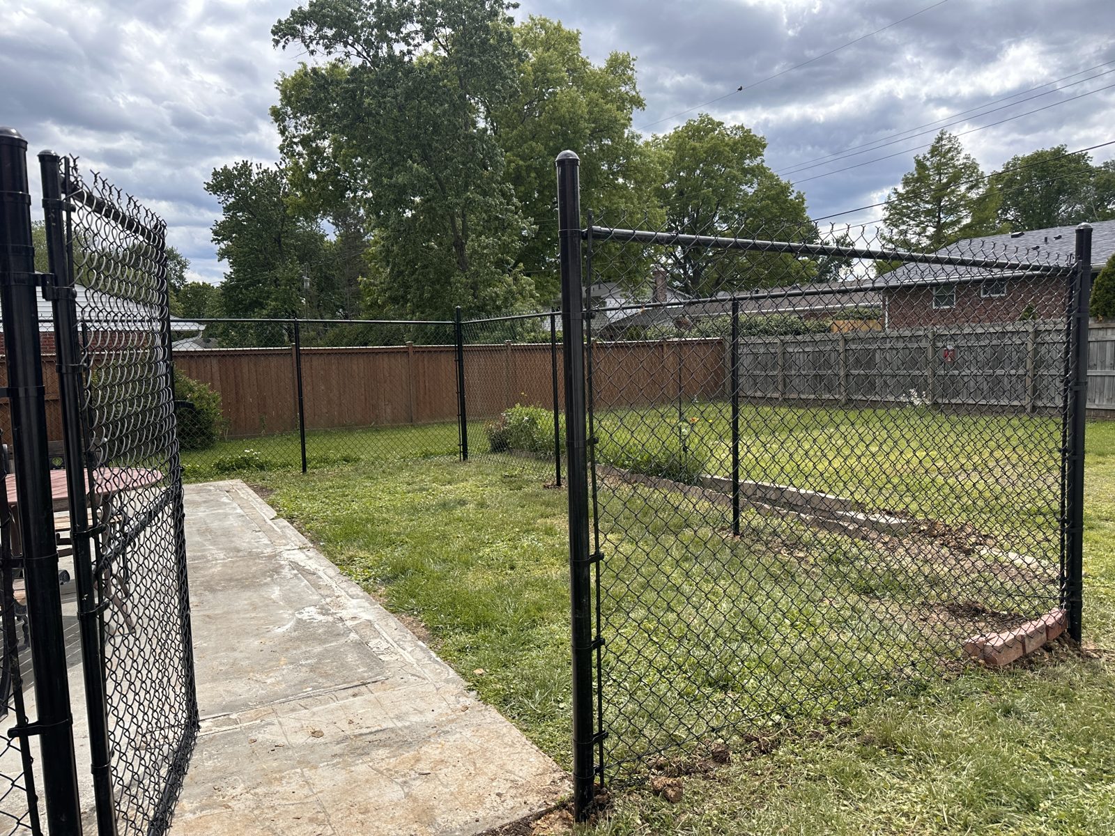 Black chain link fence along a back patio