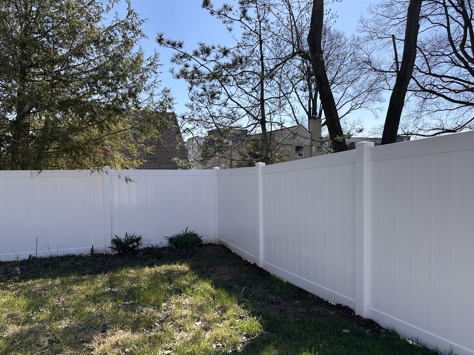 White vinyl privacy fence corner in a Cincinnati backyard
