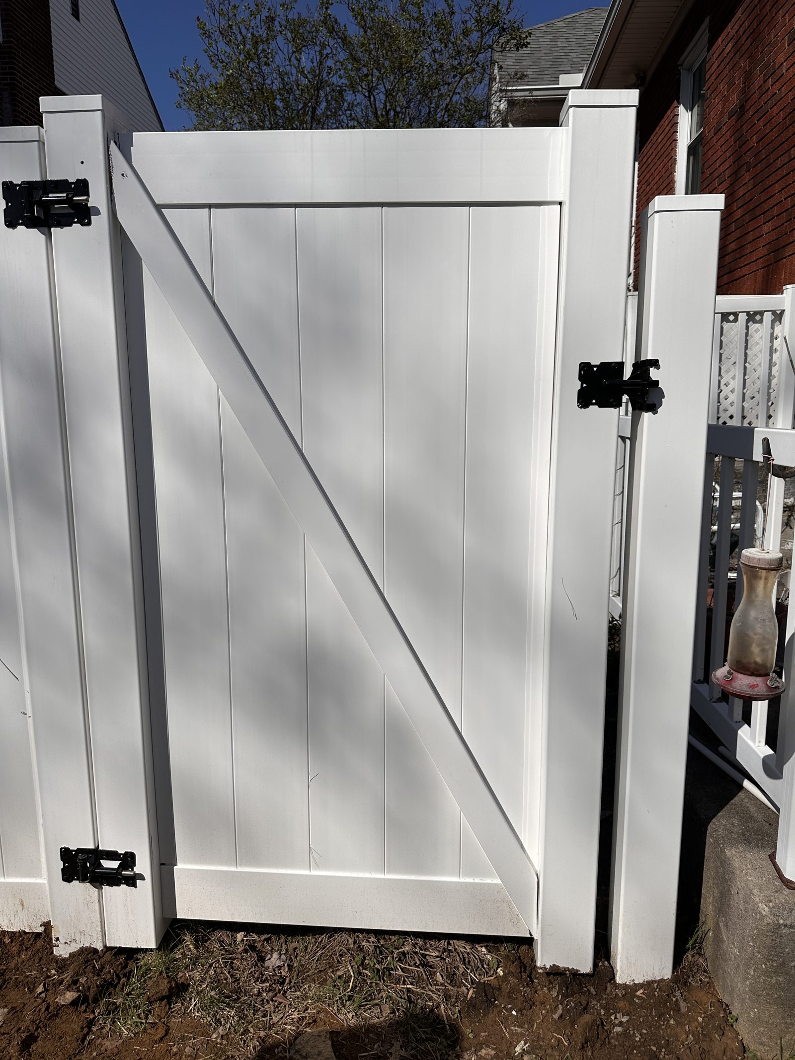 White vinyl gate with black hardware