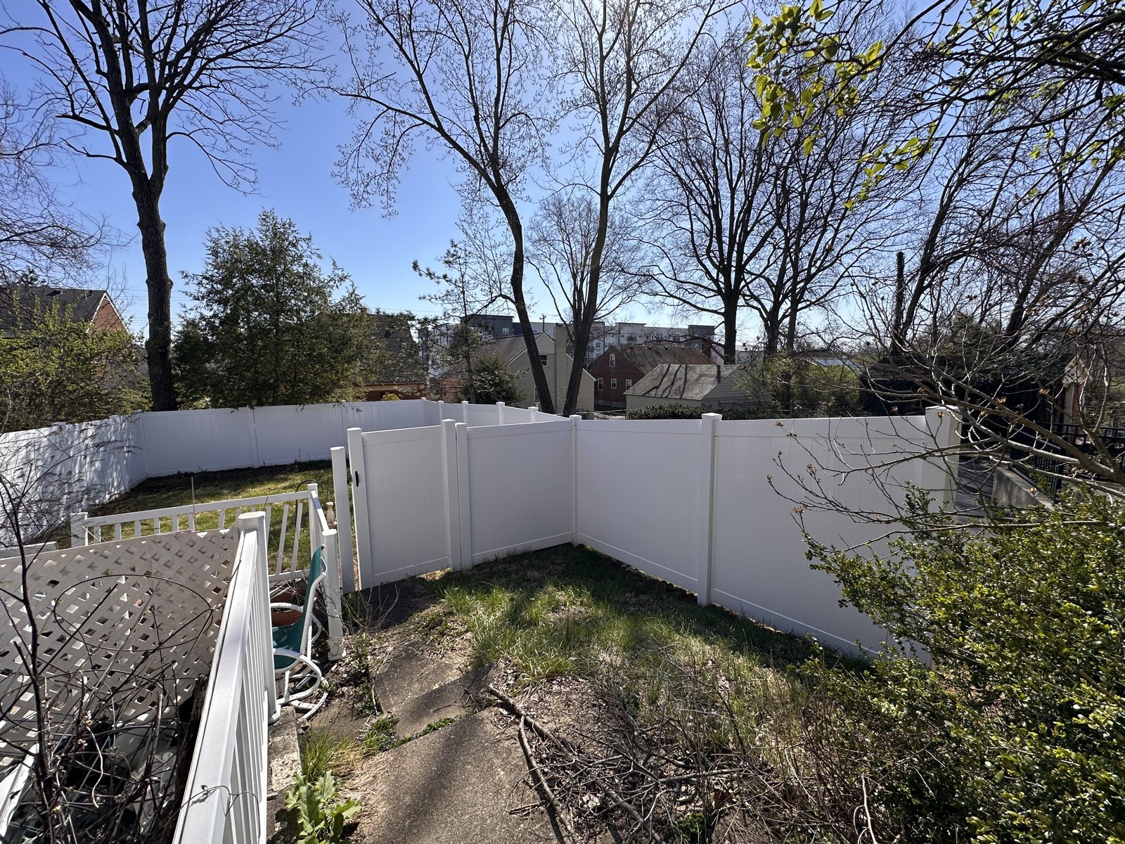 White vinyl privacy fence along a side yard