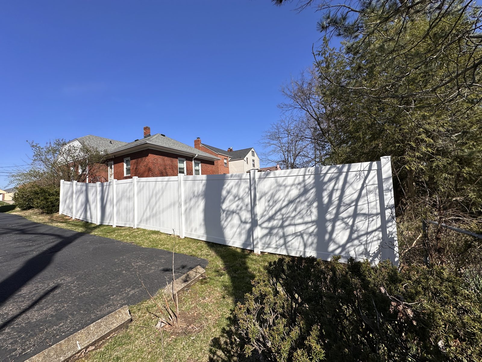 White vinyl privacy fence and brick home in Cincinnati