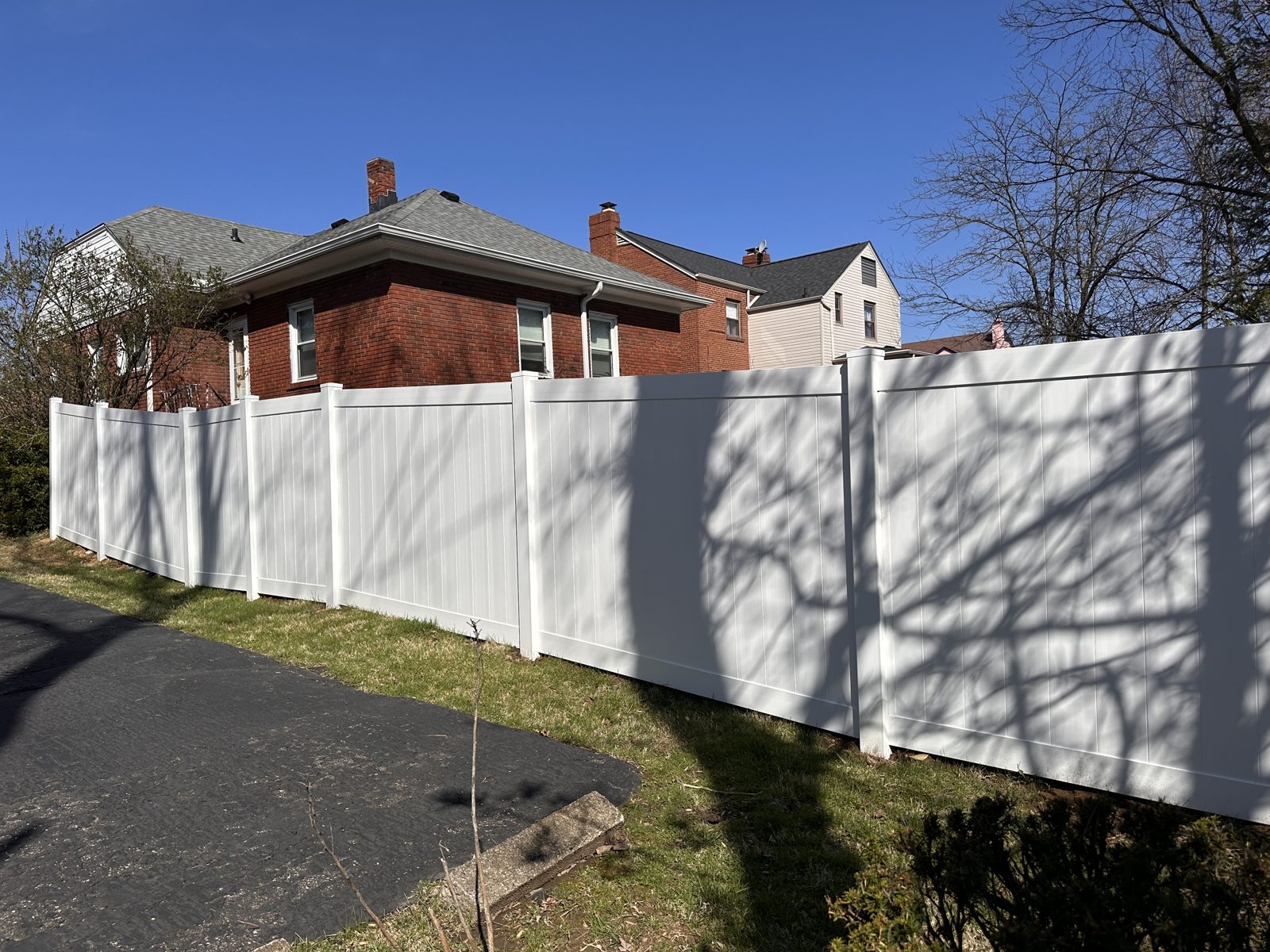 Long white vinyl privacy fence along a Cincinnati street