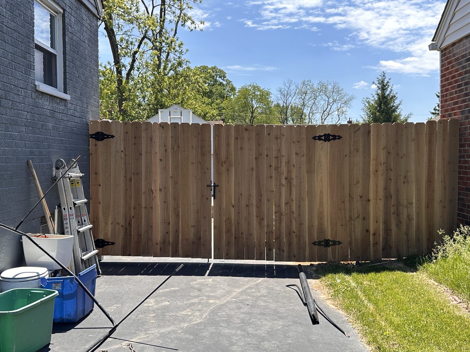 Wood privacy double gate across a driveway