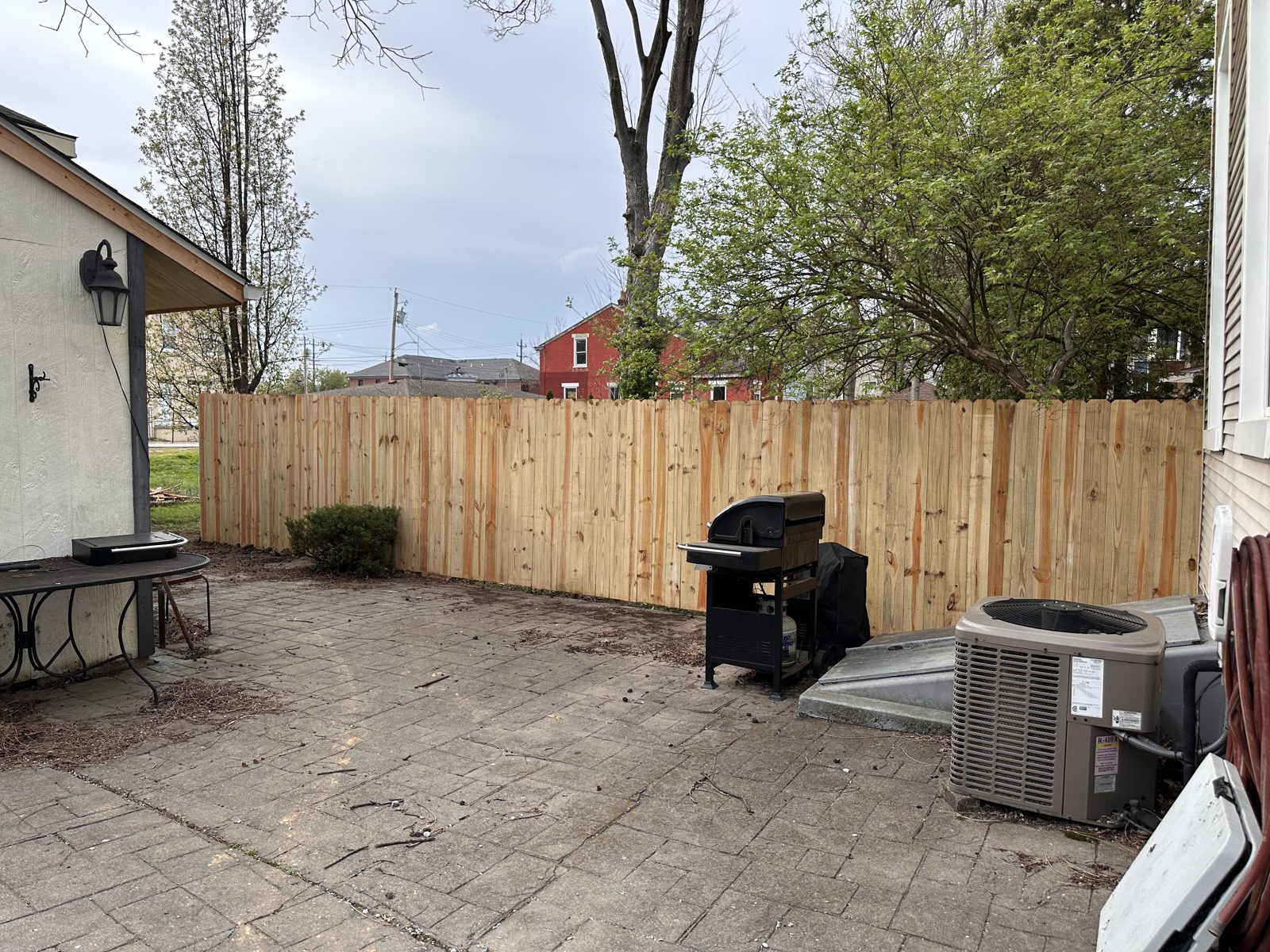 Wood privacy fence enclosing a grill patio