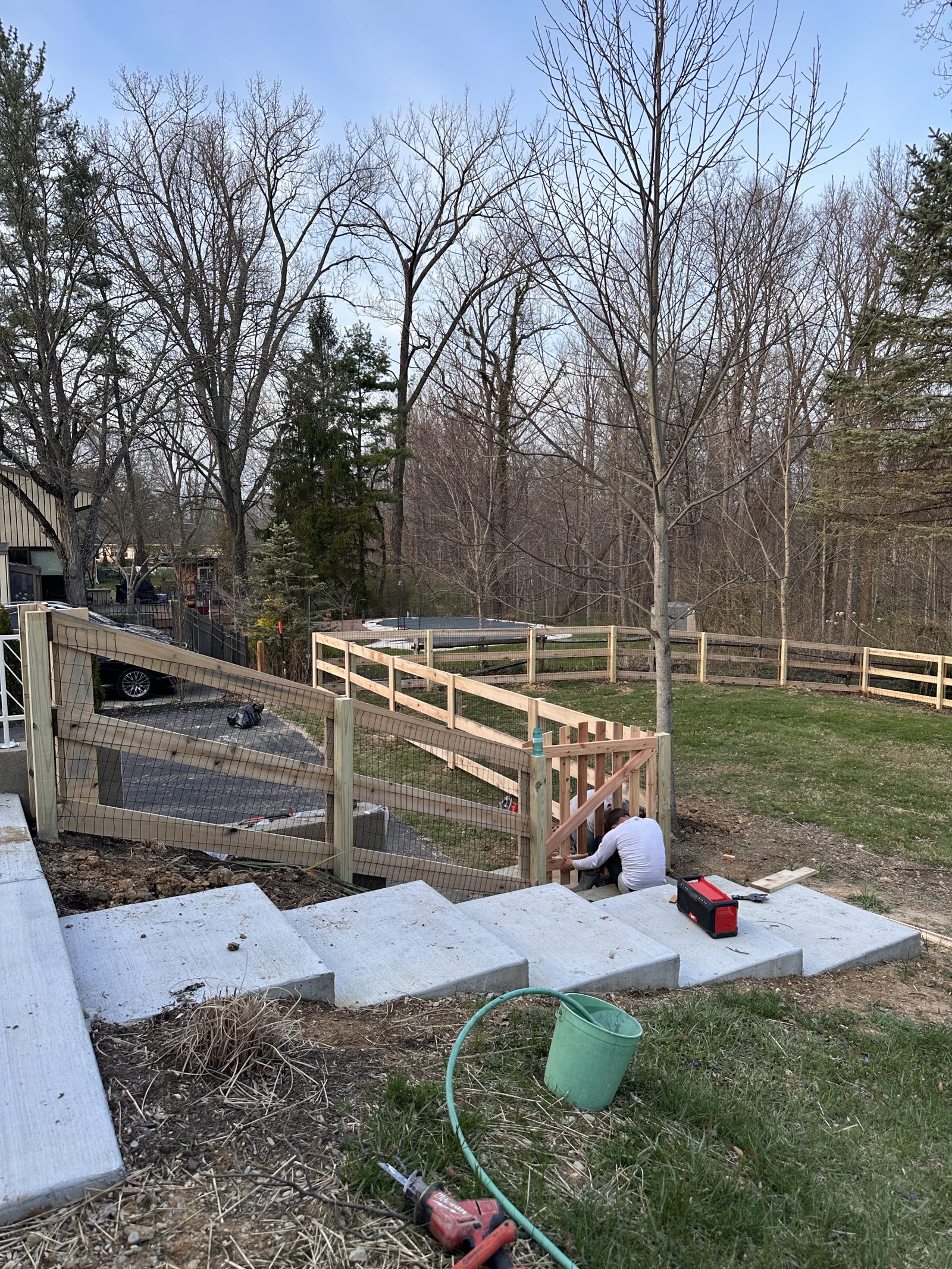Heartwood crew setting split rail fence posts