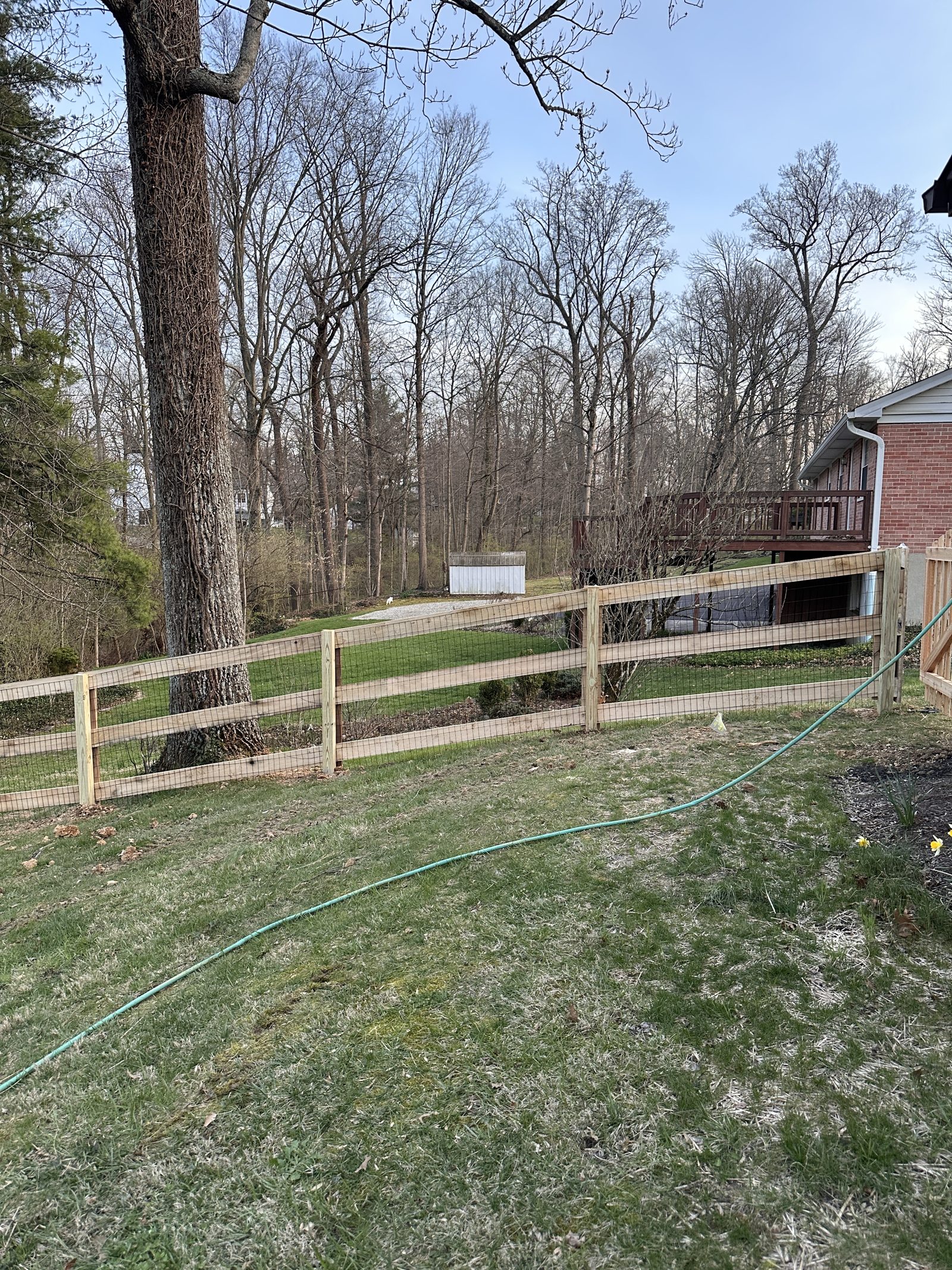 Crew member installing a split rail fence line
