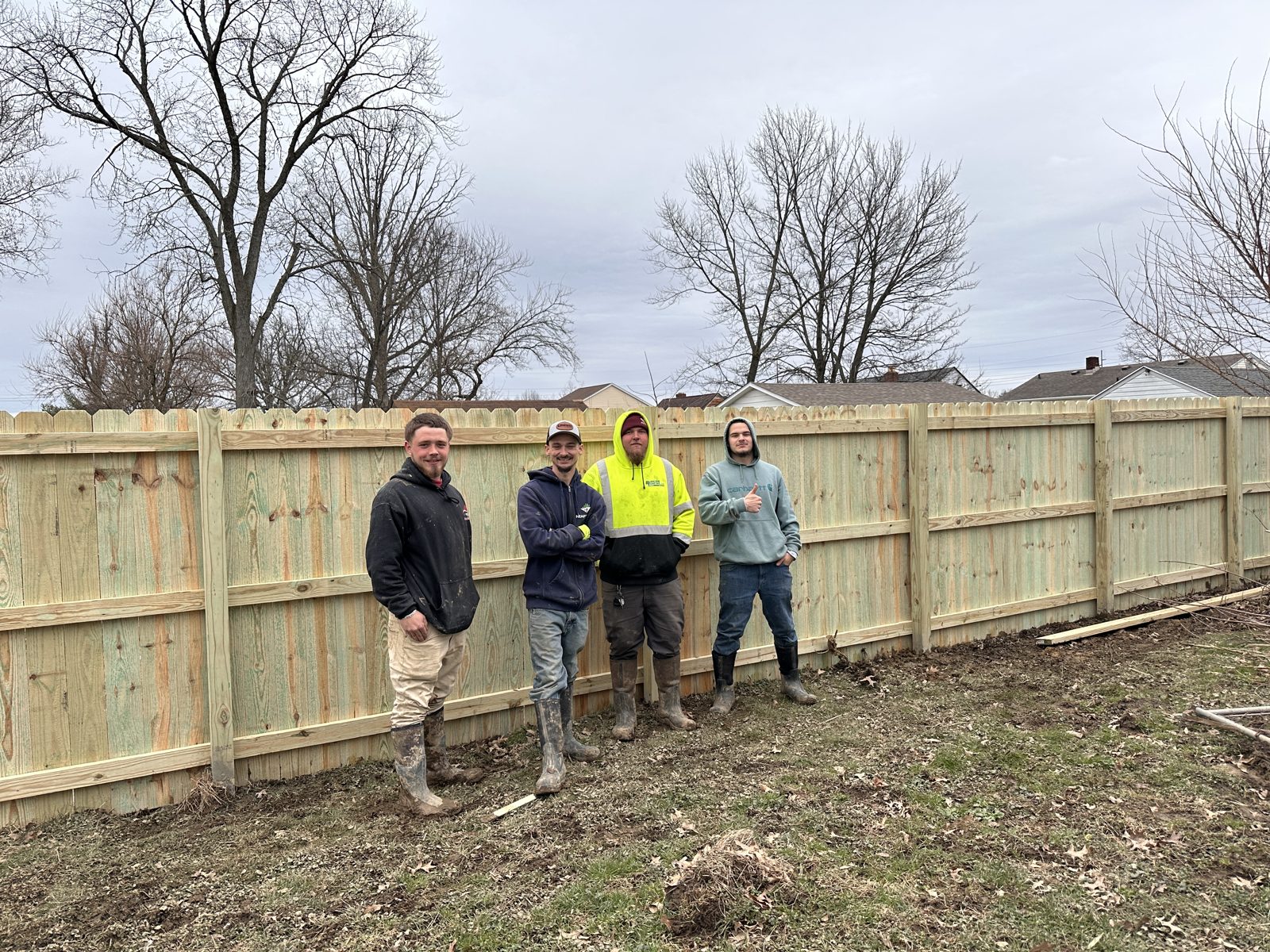 Heartwood Fence crew in front of a finished wood privacy fence in Cincinnati