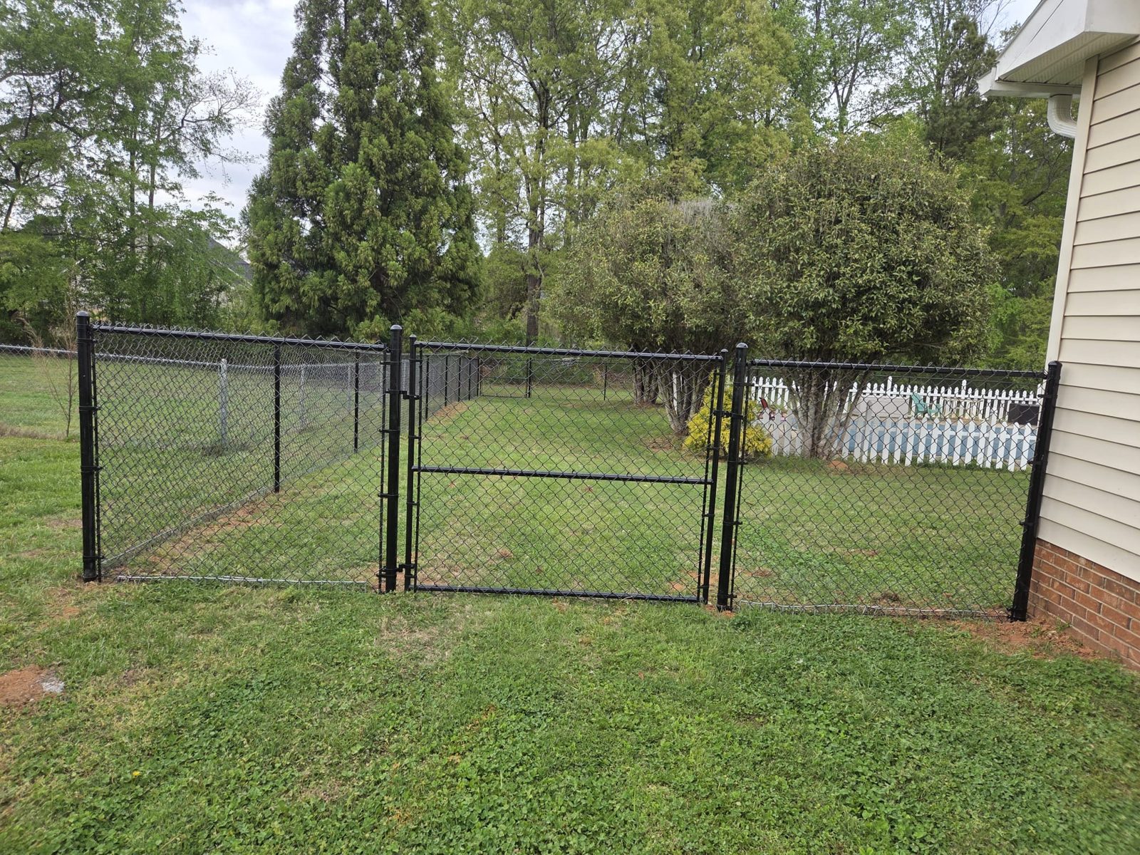 Black chain link double gate at a Greenville home