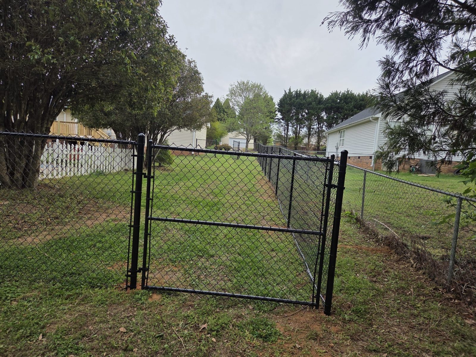 Black chain link fence and walk gate in Greenville