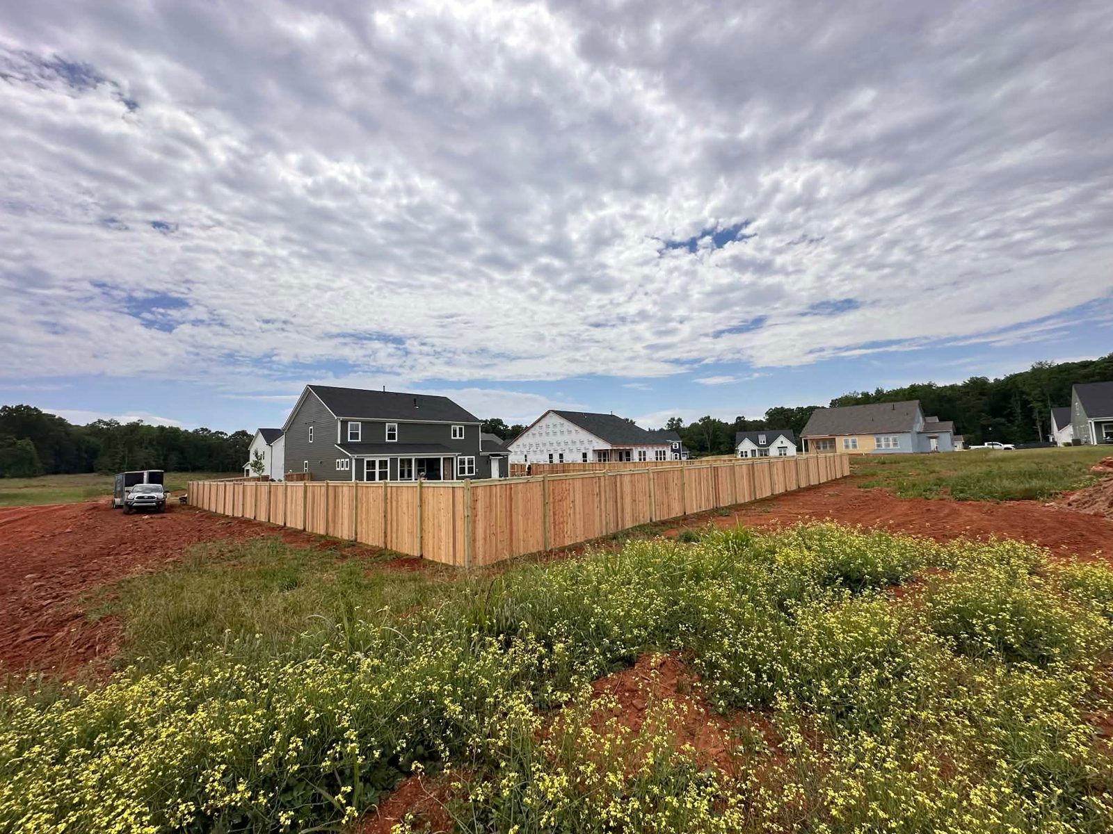 Wood privacy fence corner on a new-build lot in Greenville