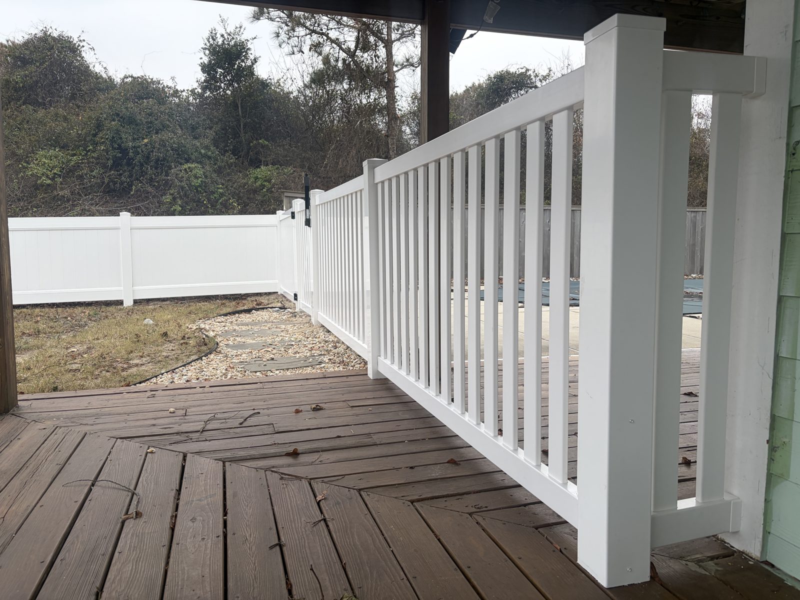White vinyl picket fence and porch railing