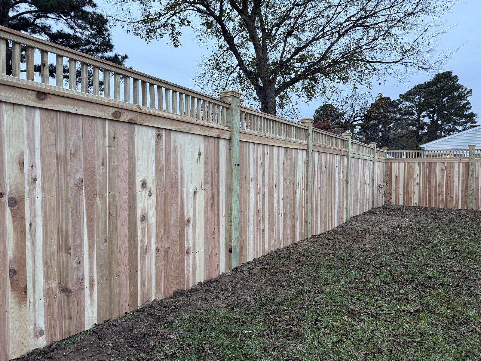 Board-on-board wood privacy fence